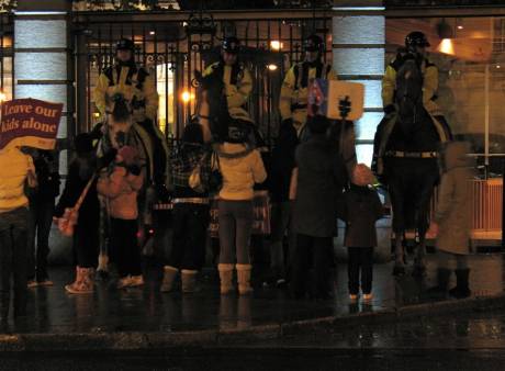 Children play with riot horses