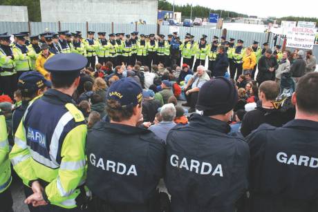 Campaigners sitting on the road, surrounded by gardai