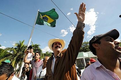 Mr Z waving (not saluting) with that flag in the background.