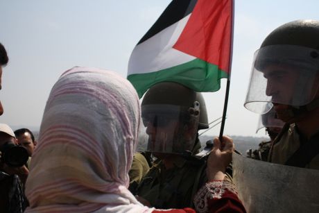 Woman handed palestine flag at Bil'in Demonstration against Apartheid wall